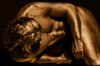Golden male nude close-up with defined muscular torso, luxury fine art wall photography