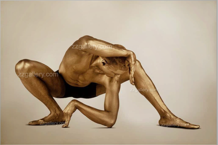 Fine art photograph of a golden-painted male figure in a powerful yoga stretch, symbolizing strength, flexibility, and meditation. Ideal wall art for yoga studios, wellness spaces, meditation rooms, and contemporary art collectors.