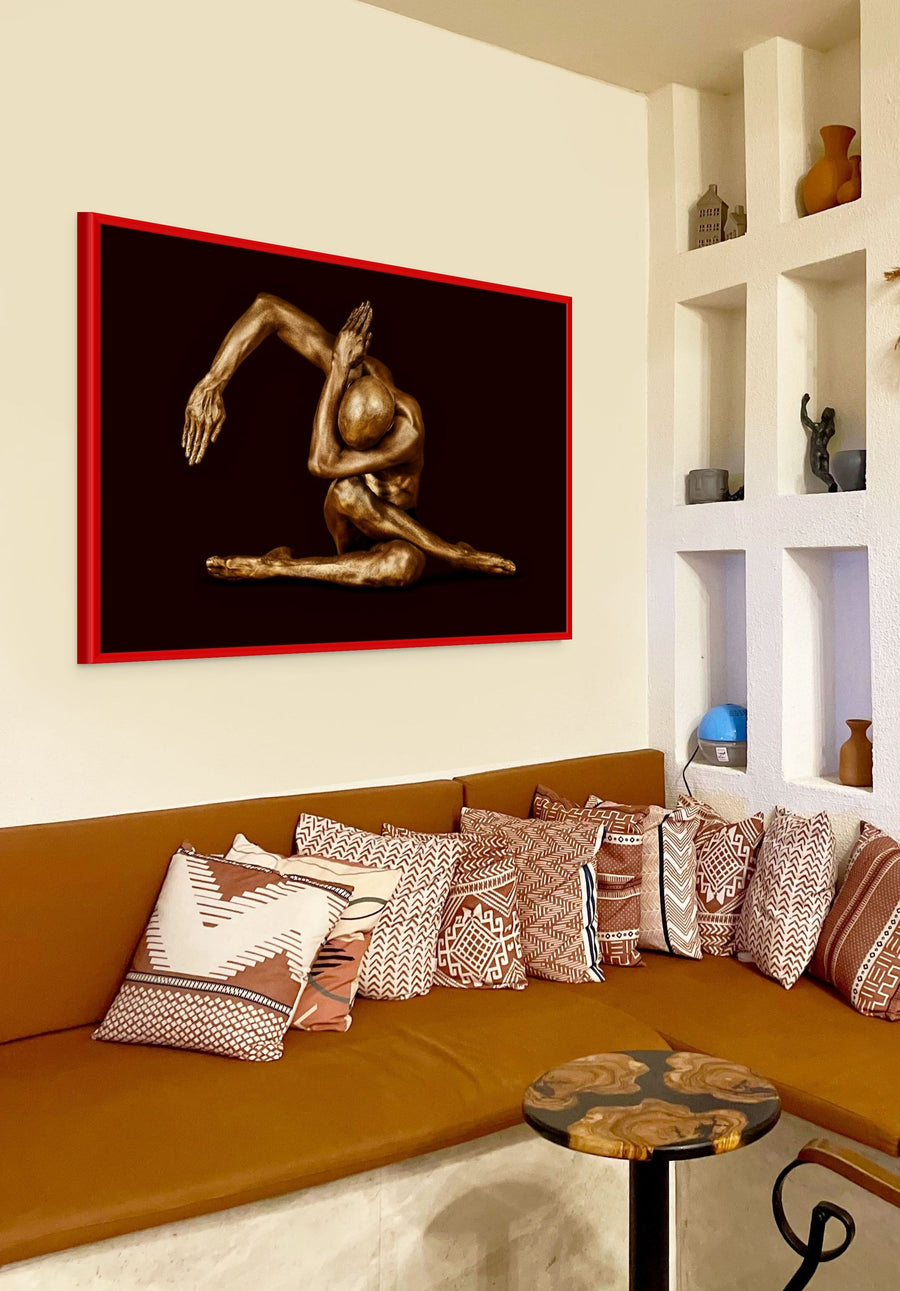 Golden-painted male figure in a sculptural seated yoga pose with extended arm, fine art photography by Zack Zublena from the Dark Elegance collection.