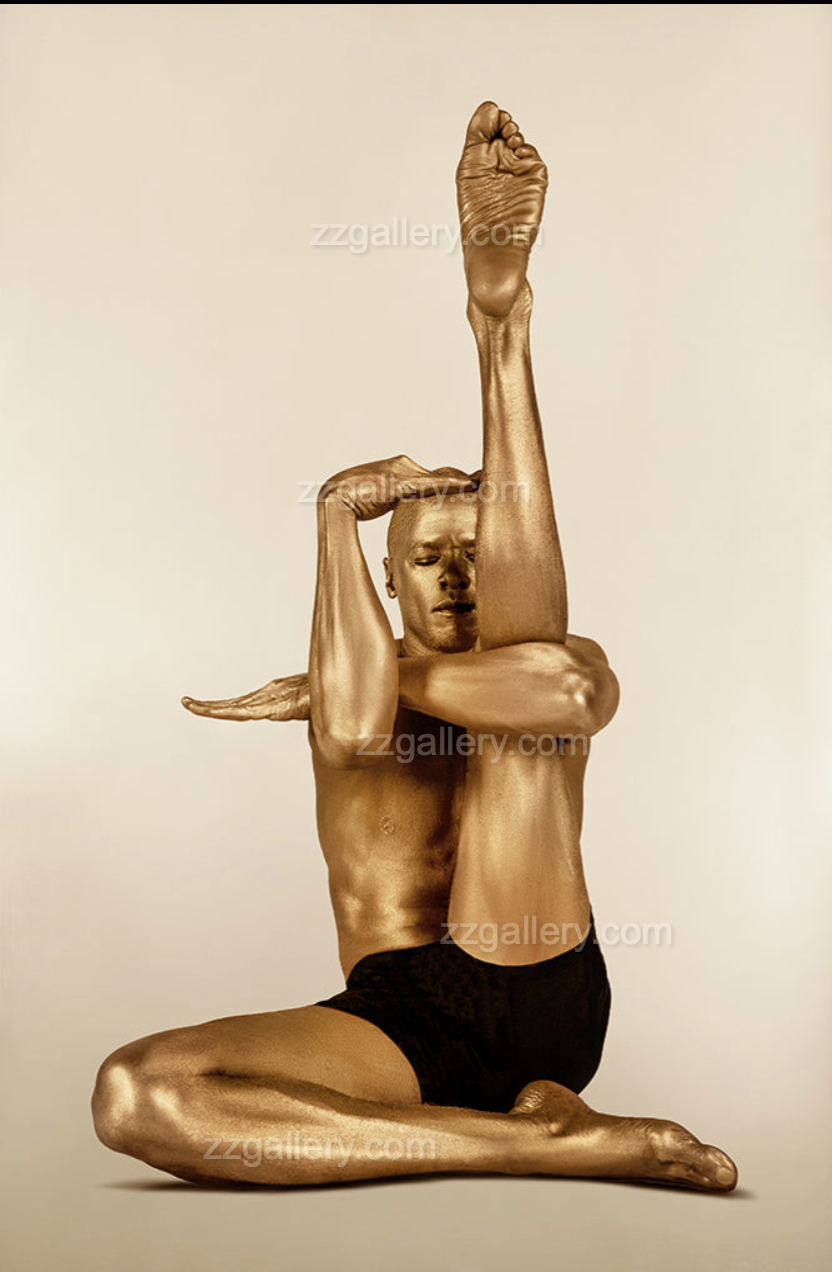 Golden-painted male figure in a contemporary yoga stretch pose, conceptual fine art photography by Zack Zublena, luxury wall art for modern interiors.