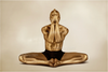 Golden-painted male yogi seated in lotus pose with hands in prayer over face – sacred meditation wall art photography