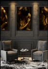 Golden-painted male torso fine art photography by Zack Zublena displayed in a luxury interior mockup with dark wall paneling and armchairs