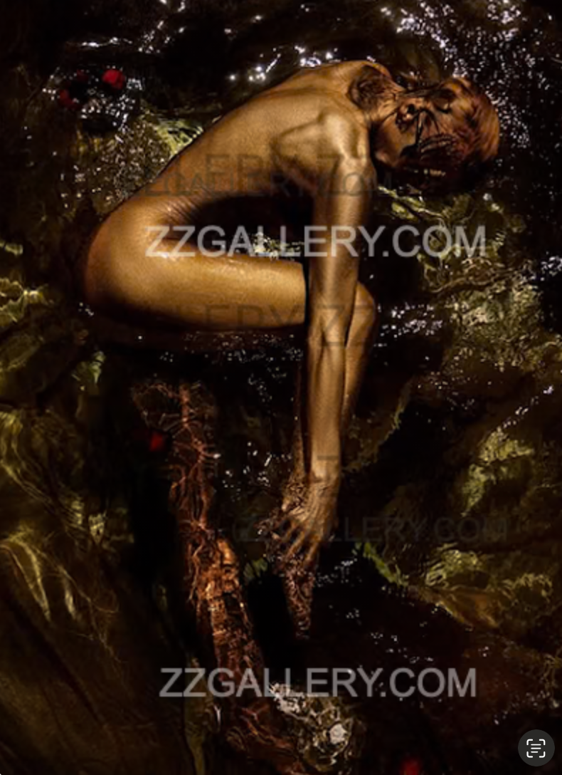 Golden-painted nude woman in surreal yoga-like pose over water, wearing mask