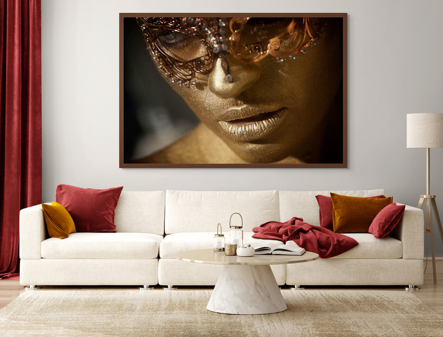 Luxury fine art photography of a golden-painted face wearing an ornate masquerade mask, contemporary wall art by Zack Zublena.