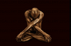Golden-painted male figure in meditation pose with crossed arms – fine art photography by Zack Zublena, spiritual masculine wall art