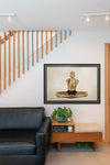 Golden-painted male figure in cross-legged yoga meditation pose, hands raised in prayer, conceptual fine art wall decor by Zack Zublena.