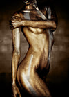 gold and bronze-painted female torso in close-up — fine art photograph emphasizing curves, strength, and divine sensuality