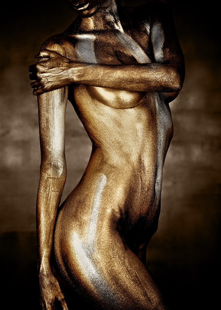 gold and bronze-painted female torso in close-up — fine art photograph emphasizing curves, strength, and divine sensuality