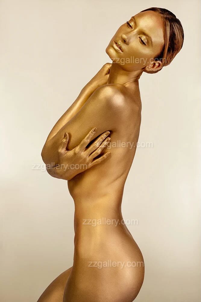 Golden nude woman in elegant sculptural pose, luxury wall art photography