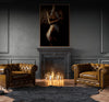 Golden nude fine art photograph of a female figure with shimmering gold and silver body paint, displayed above a black marble fireplace in a luxury interior.