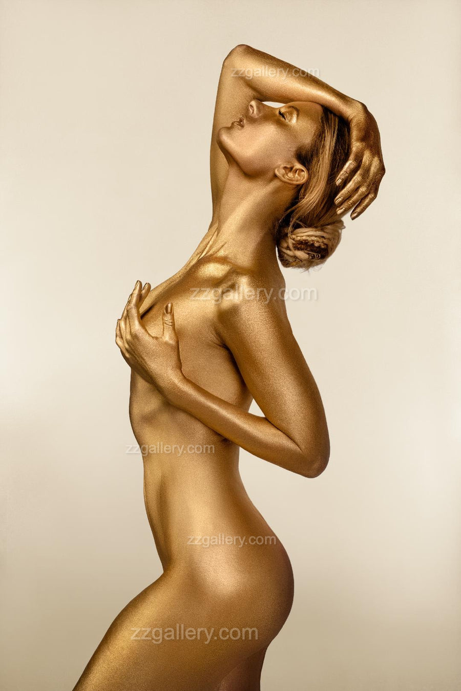 Golden-painted nude woman in a graceful side silhouette, captured in a poised artistic pose that highlights elegance, sensuality, and divine feminine energy – fine art wall decor by Zack Zublena.
