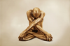 Nude male yogi painted in gold, seated in lotus with arms crossed in deep meditation – fine art wall photography