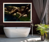 Golden-painted nude woman reclining on a shimmering gold float over deep blue water, illuminated dramatically to highlight curves and textures. Luxurious fine art nude photography symbolizing freedom, sensuality, and divine elegance, ideal for spas, boutique hotels, and contemporary collectors.