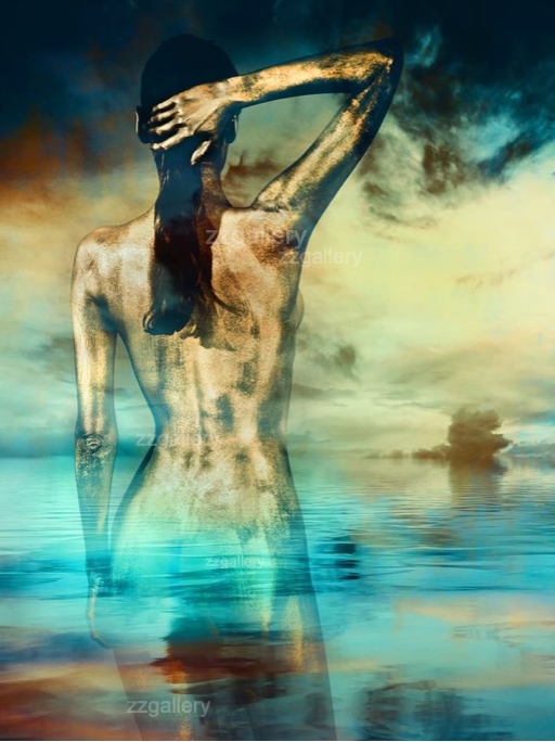 Golden-painted nude woman with hand in hair, standing waist-deep in the sea, merging with sky and water reflections in a surreal fine art composition by Zack Zublena.