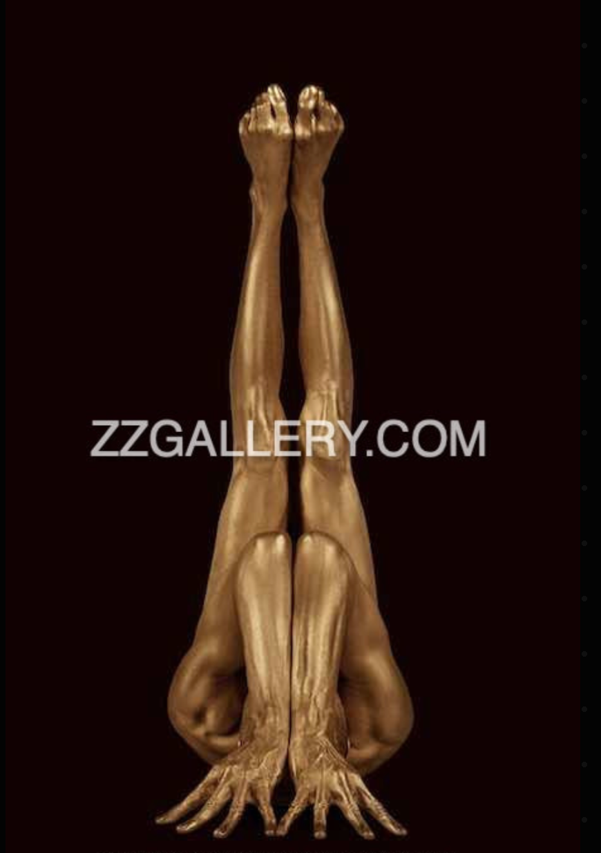 All-time favorite golden nude in an iconic vertical pose with sculptural legs extended upward, evoking sacred geometry and divine balance.