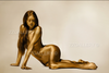 Golden nude woman with long red hair in sensual pose, luxury fine art photography for hotels, spas, and contemporary interiors