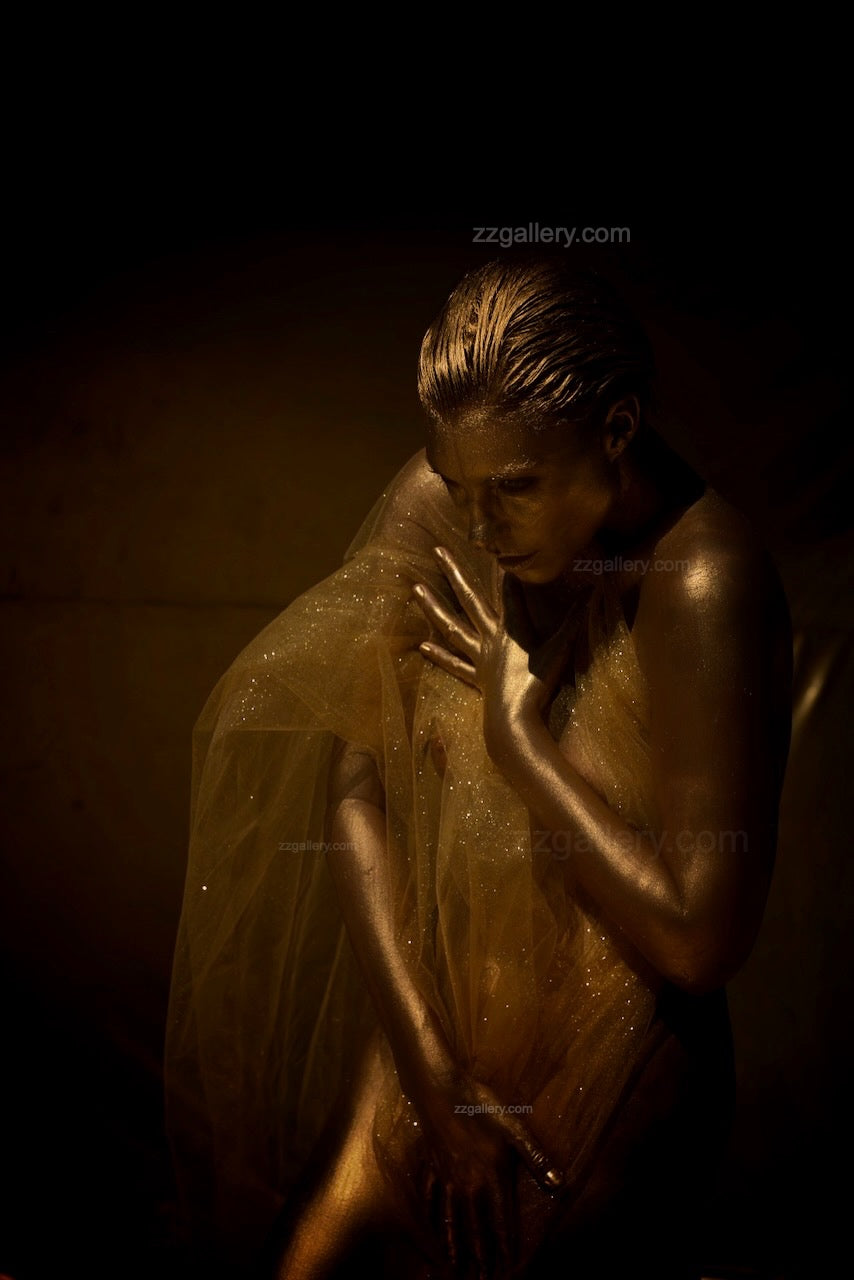 Golden-painted figure draped in a translucent veil, illuminated in warm golden light, fine art wall decor for luxury interiors and wellness spaces.