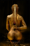 Golden-painted warrior woman kneeling with ceremonial sword, fine art photography celebrating divine feminine strength, luxury wall art.