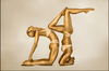 Two golden-painted figures in synchronized yoga poses – fine art photography by Zack Zublena, luxury wall art for wellness, meditation, and interiors.