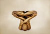Golden-painted nude figure folded in a crossed-body yoga pose, conceptual fine art photograph by Zack Zublena symbolizing transcendence and quantum field awareness.
