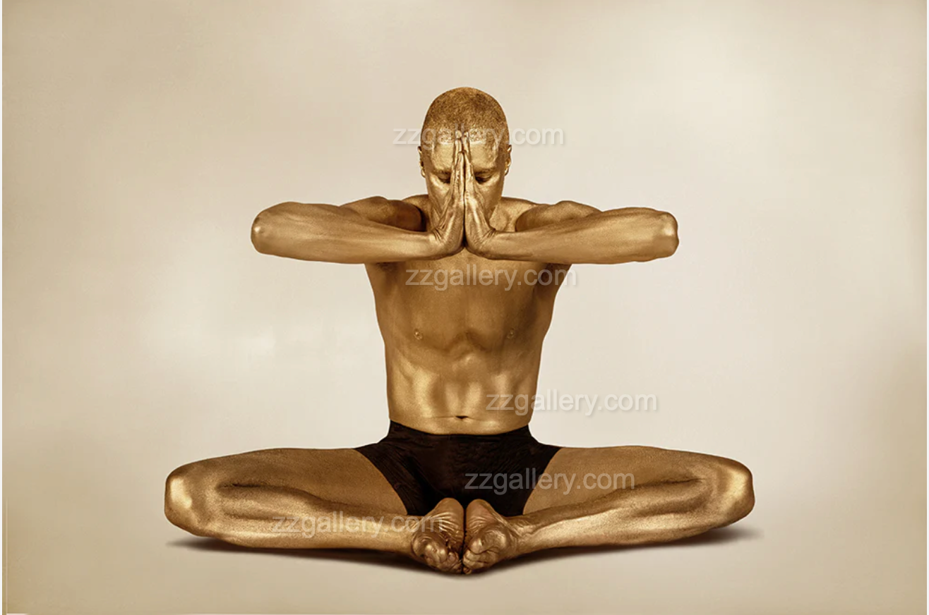 Golden-painted male yogi in lotus pose with arms extended in Anjali Mudra – fine art wall photography