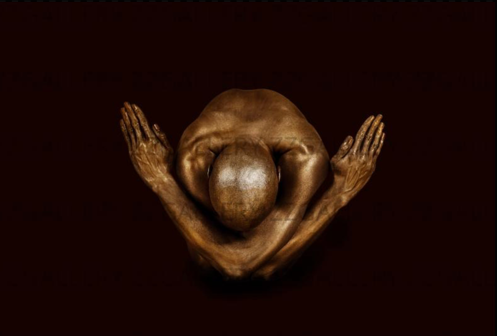 Golden yogi in powerful prayer pose, arms crossed like angel wings on deep burgundy background.