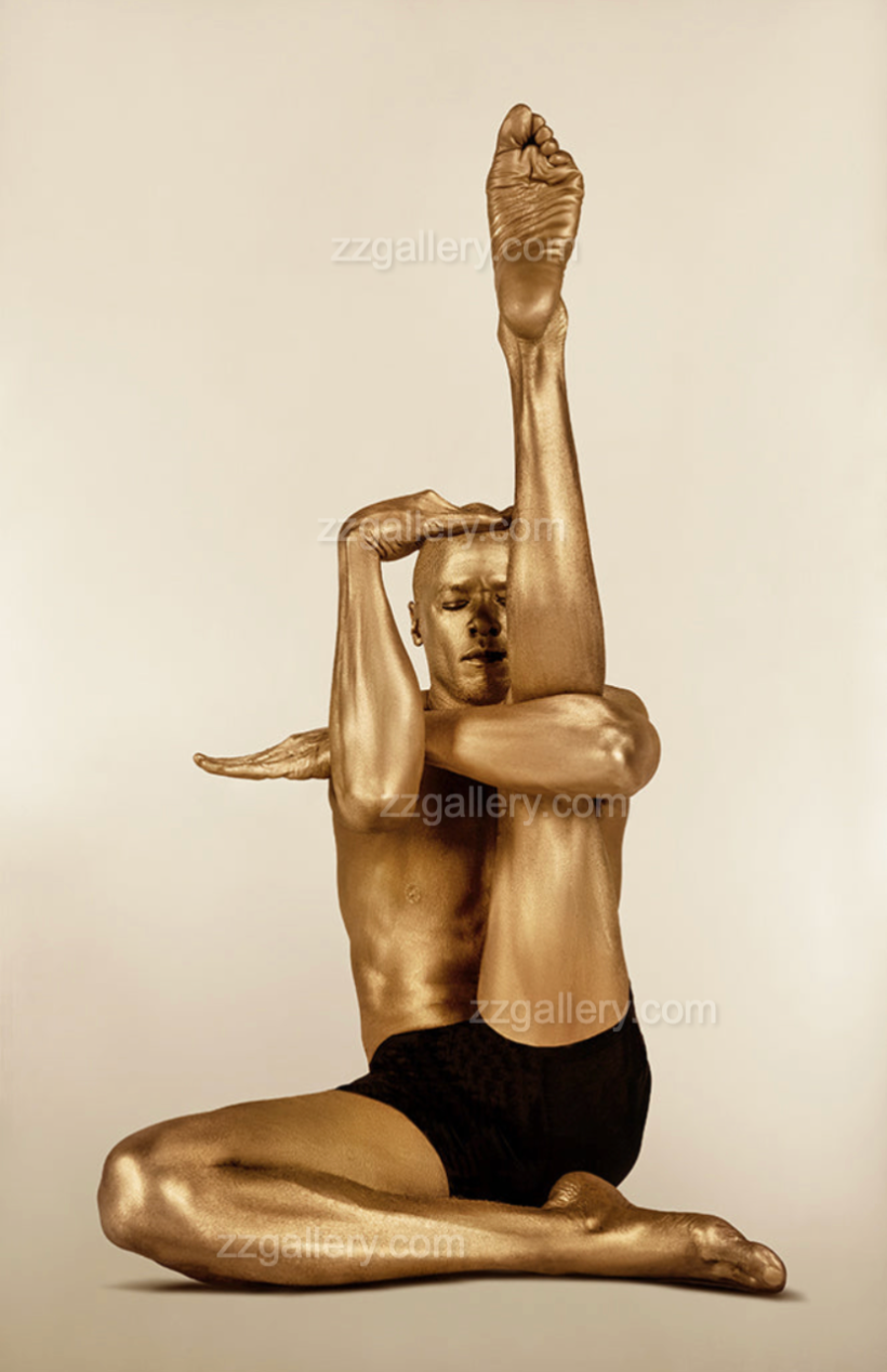 Golden-painted male figure in a contemporary yoga stretch pose, conceptual fine art photography by Zack Zublena, luxury wall art for modern interiors.