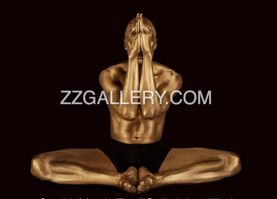 Golden-painted male yogi seated in lotus pose with hands in prayer over face – sacred meditation wall art photography
