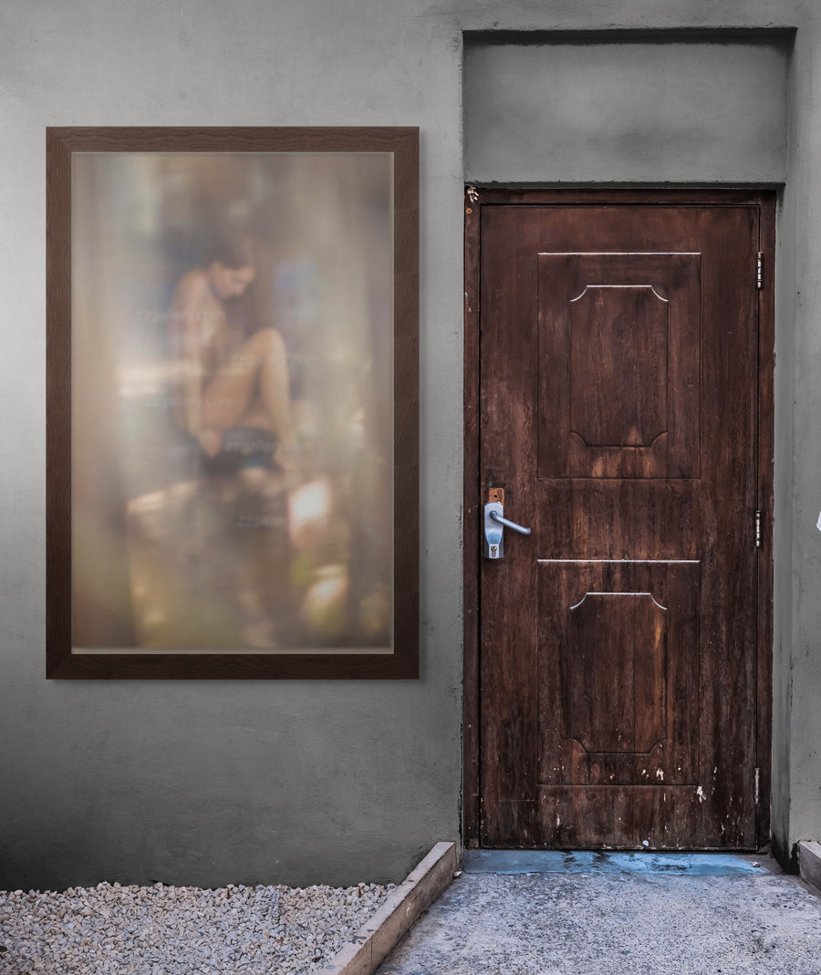 Framed golden reflection fine art photograph displayed on an outdoor wall beside a rustic wooden door, blending nature, light, and contemporary backyard design.