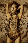 Woman in leopard bodysuit with arms raised and eyes closed, blended with the intense stare of a leopard, symbolizing wild beauty, sensuality, and feline spirit in fine art photography by Zack Zublena.