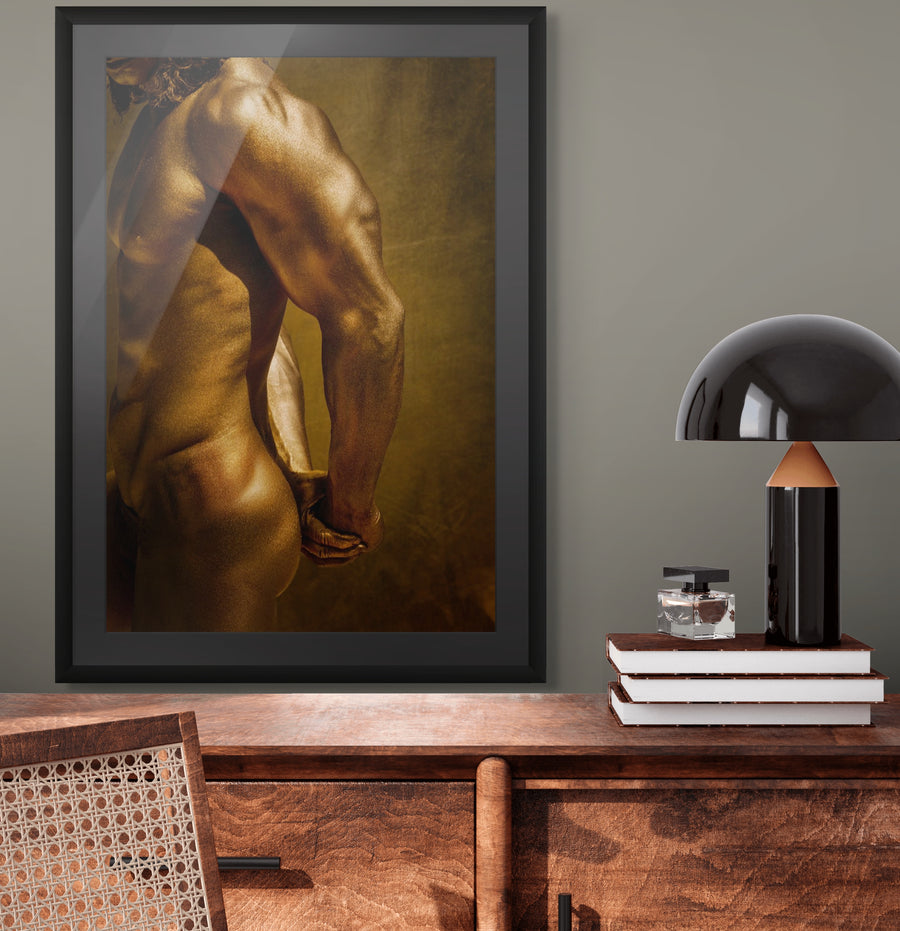 Golden male figure artwork by Zack Zublena – sculpted back and arms painted in shimmering gold, displayed in a modern interior.