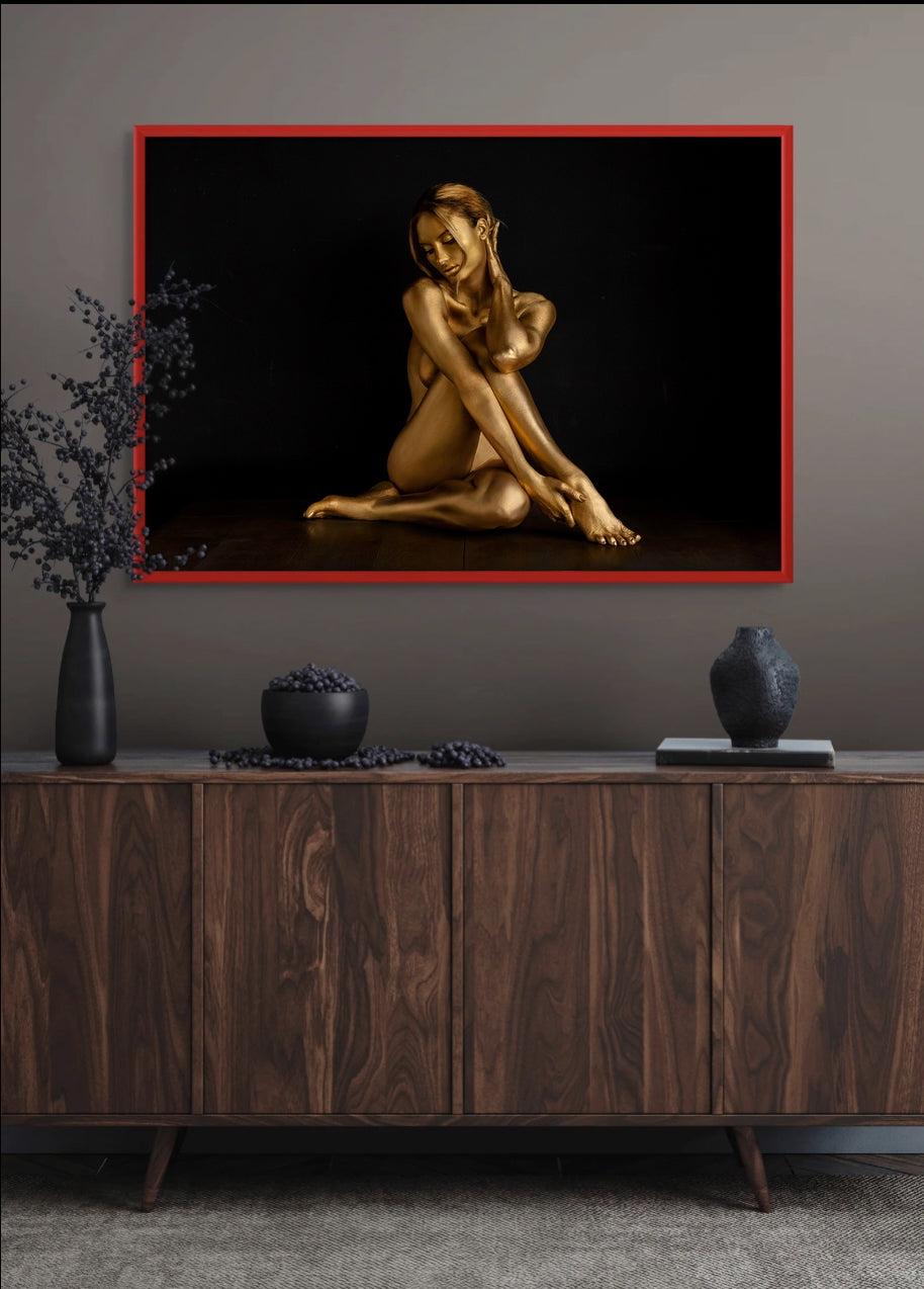Moonlit Reverie III by Zack Zublena, a seated gold-painted woman in fine art photography, framed in red above a walnut sideboard with dark vases, Dark Elegance collection