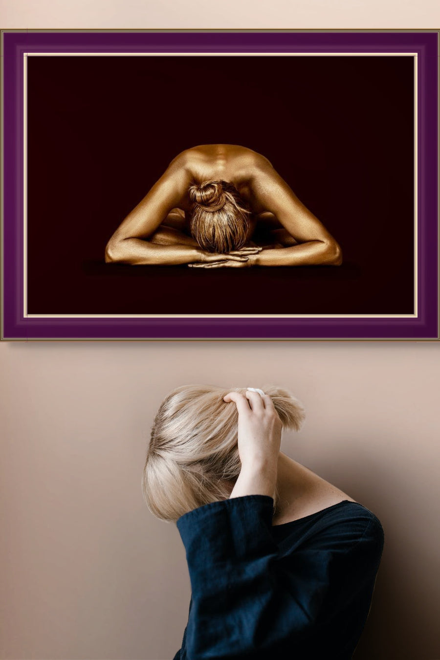 Golden-painted female figure resting forward with arms extended, fine art photography by Zack Zublena titled "Royal Rest," contemporary dark background wall art for interiors and collectors.
