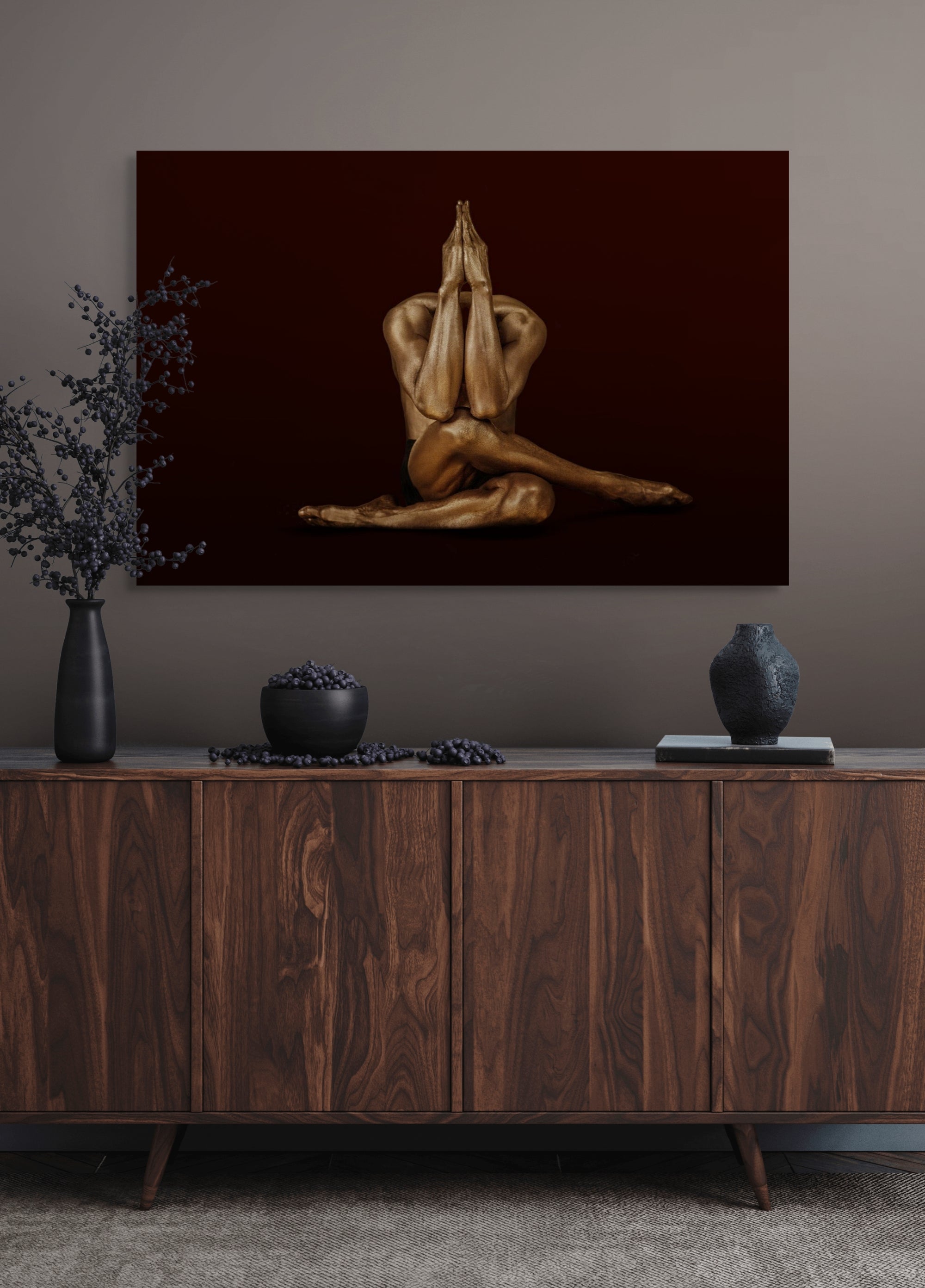 Golden-painted yogi in prayer pose, seated with crossed legs and hands pressed together, symbolizing meditation, devotion, and spiritual art.