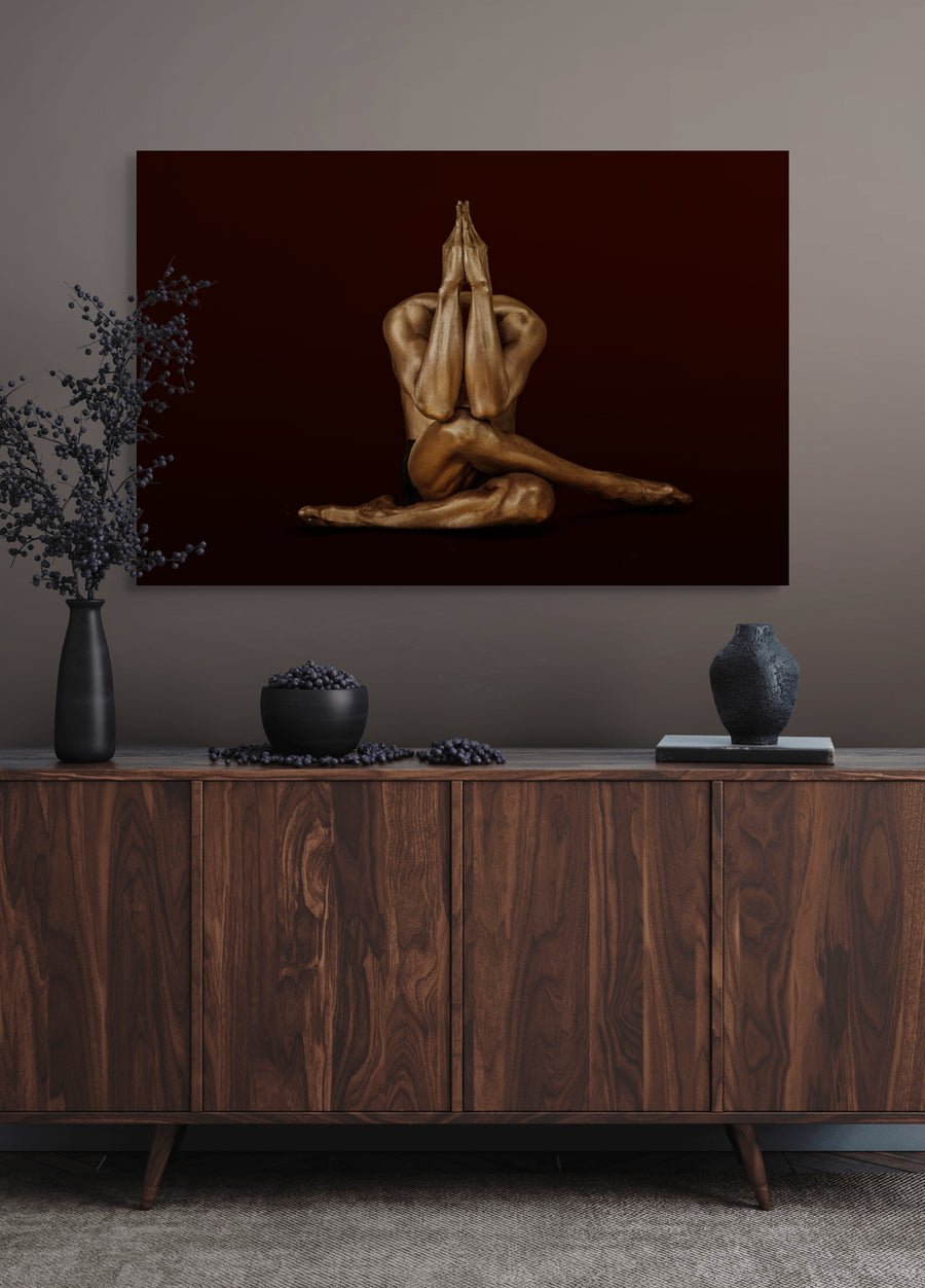 Golden-painted yogi in prayer pose, seated with crossed legs and hands pressed together, symbolizing meditation, devotion, and spiritual art.