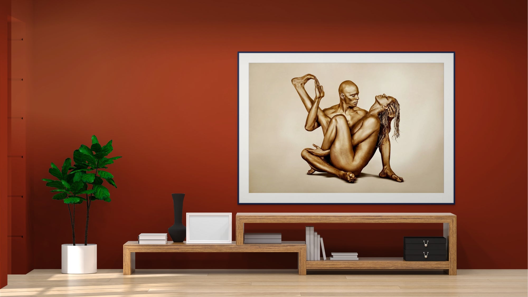 Golden sculpture of a couple in a yoga pose, symbolizing balance and unity, displayed on a gallery wall.
