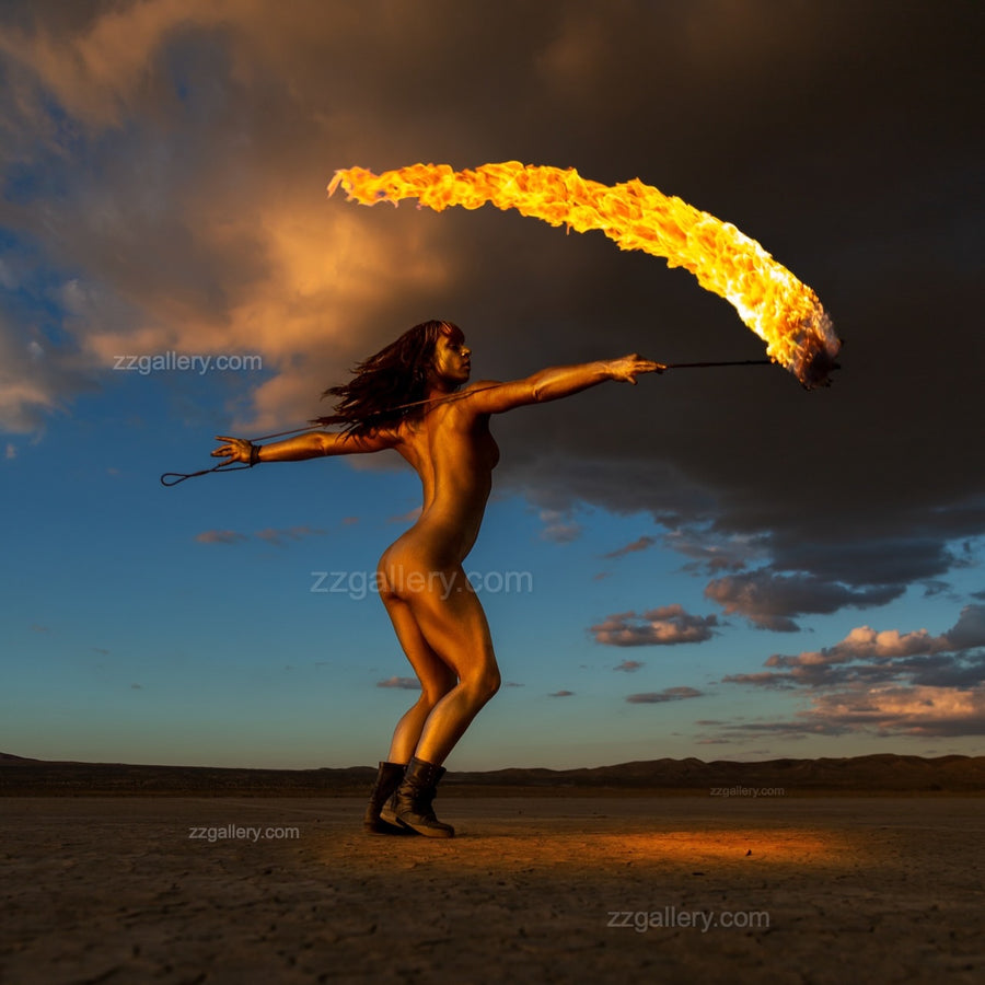 Golden-painted figure extending with sweeping flame across desert horizon – fine art photography print by Zack Zublena, Skyfall Flames Collection