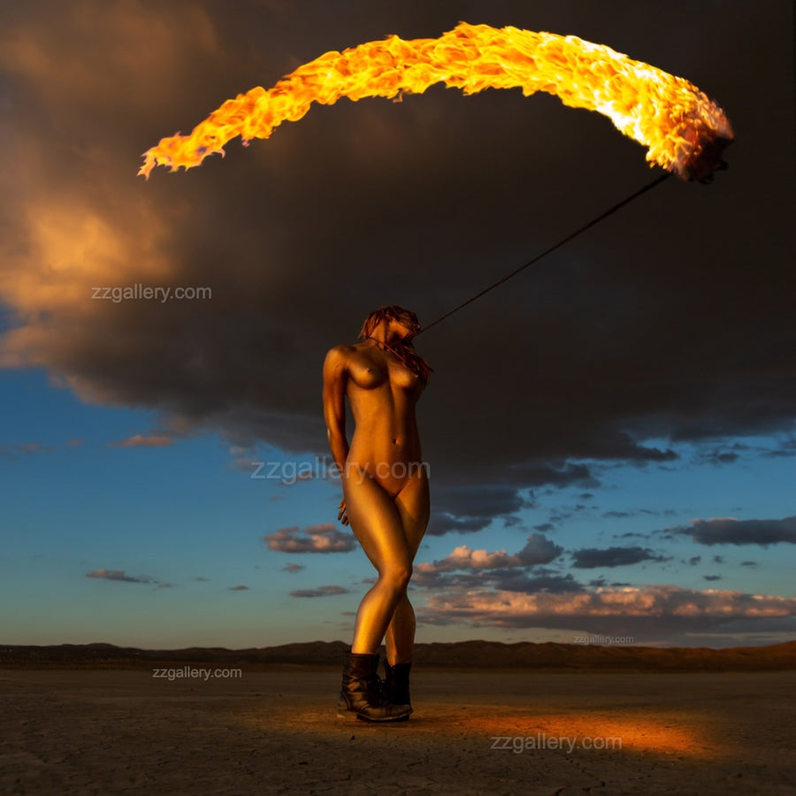 Golden-painted figure with sweeping arc of fire in desert sky – fine art photography wall art by Zack Zublena, Skyfall Flames Collection