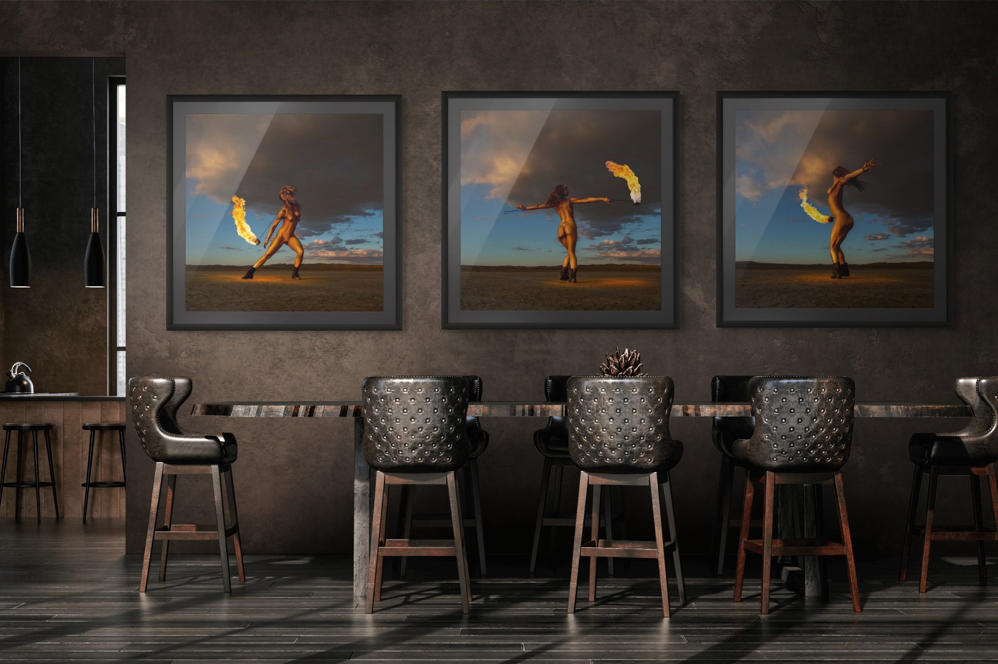 Modern interior with a triptych of fine art photography from the Skyfall Flames series, showing a golden-painted figure performing with fire under a dramatic desert sky at sunset.