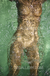 Underwater gold-painted nude in emerald water – fine art photography wall décor