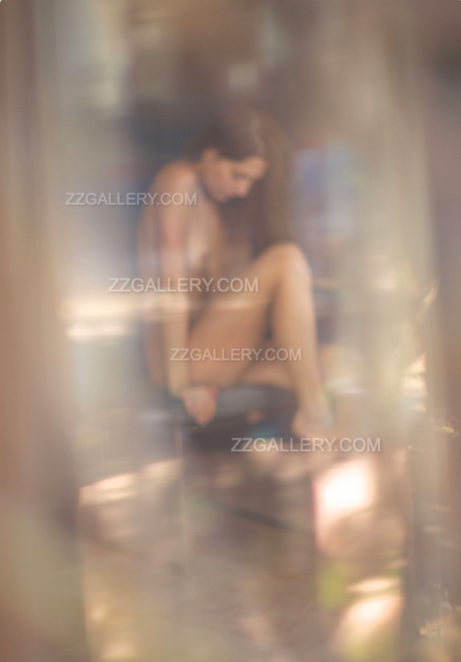Seated nude woman in soft focus and dreamy light, ethereal feminine fine art photography