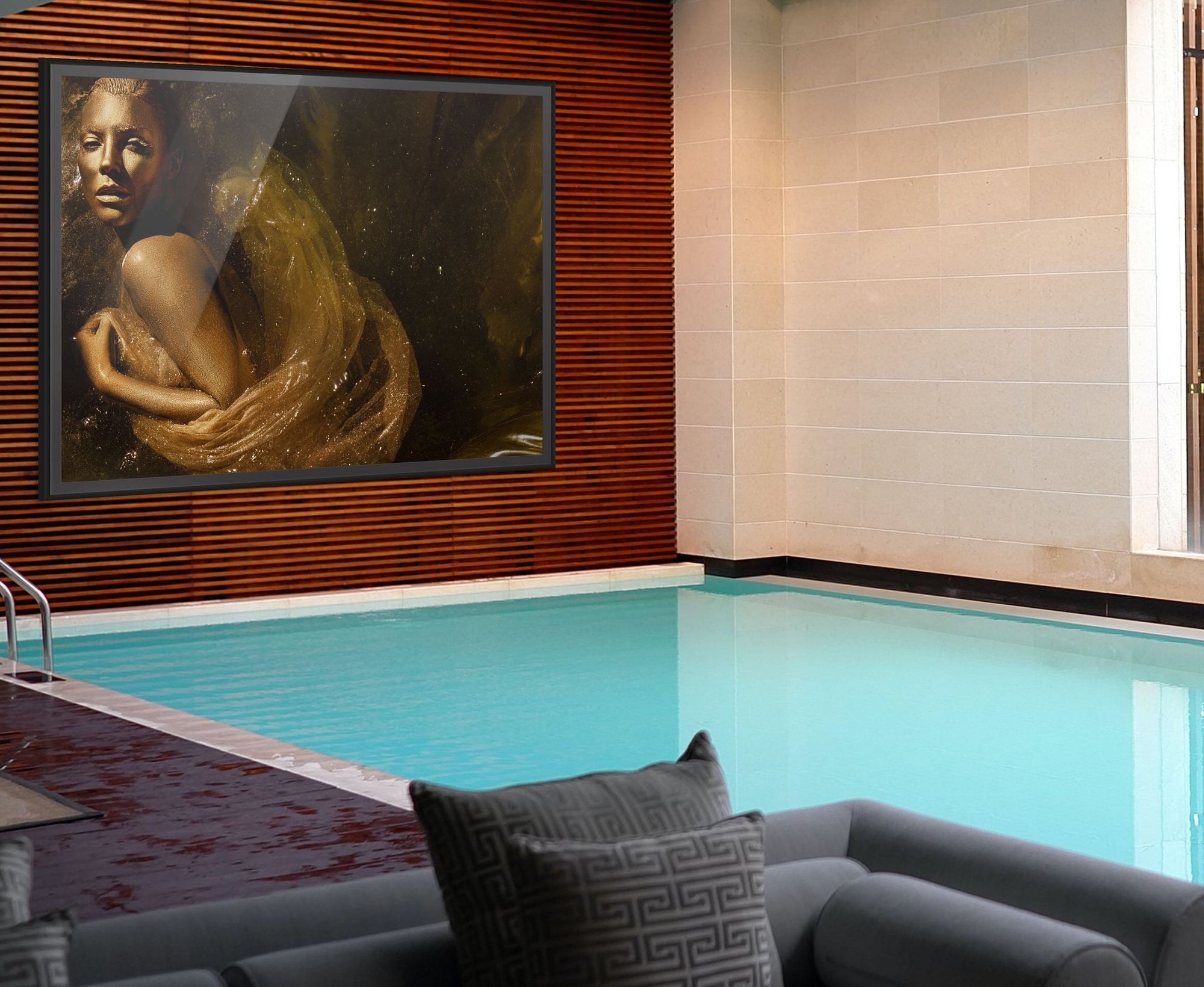 Golden Souls fine art photography print by Zack Zublena displayed in a luxury poolside interior, featuring a silhouette in shimmering gold tones draped in translucent fabric.