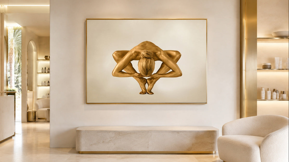Golden figurative fine art photograph by Zack Zublena displayed above a stone bench in a warm, cream-toned interior.
