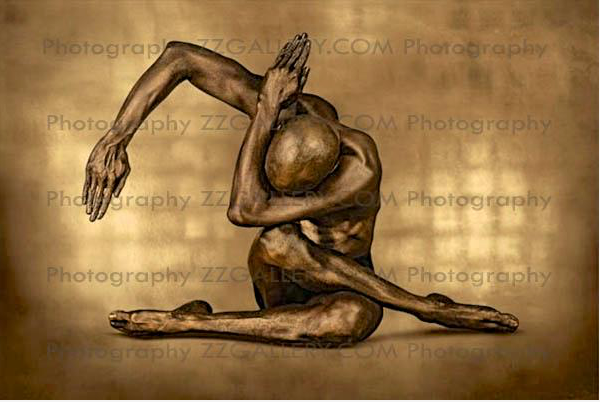 Gold-painted man in expressive yoga pose with arms curved overhead, fine art wall decor for modern spiritual or yoga interiors