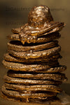 Stack of golden pancakes with melting topping – luxury fine art photography symbolizing abundance and indulgence.