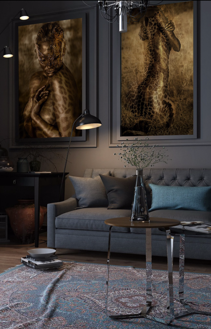 Interior view with two fine art prints featuring golden leopard-patterned figures, blending human silhouettes with feline spirit. Displayed in a modern living room above a sofa, these artworks symbolize strength, mystery, and transformation in contemporary wildlife-inspired wall décor.
