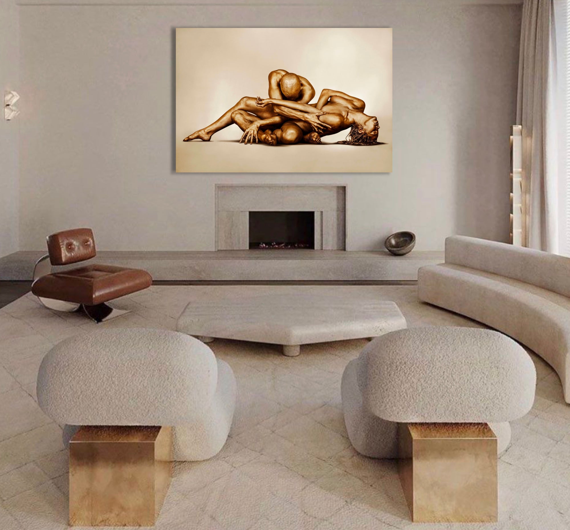 Golden-painted nude couple in a sacred surrender pose, fine art wall photography displayed in a luxury modern living room above a fireplace — elegant gold body art decor for spas, wellness retreats, and sophisticated interiors.